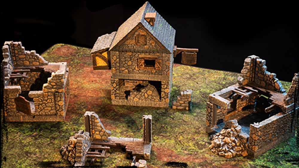 Fieldstone buildings lie in ruins atop a patched grass terrain tray
