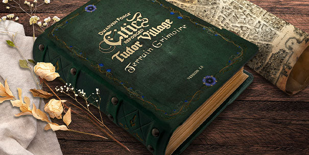 Book mock of Cities Reforged Tudor Village Terrain Grimoire, accompanied by dried flowers, and a rolled map of Valoria