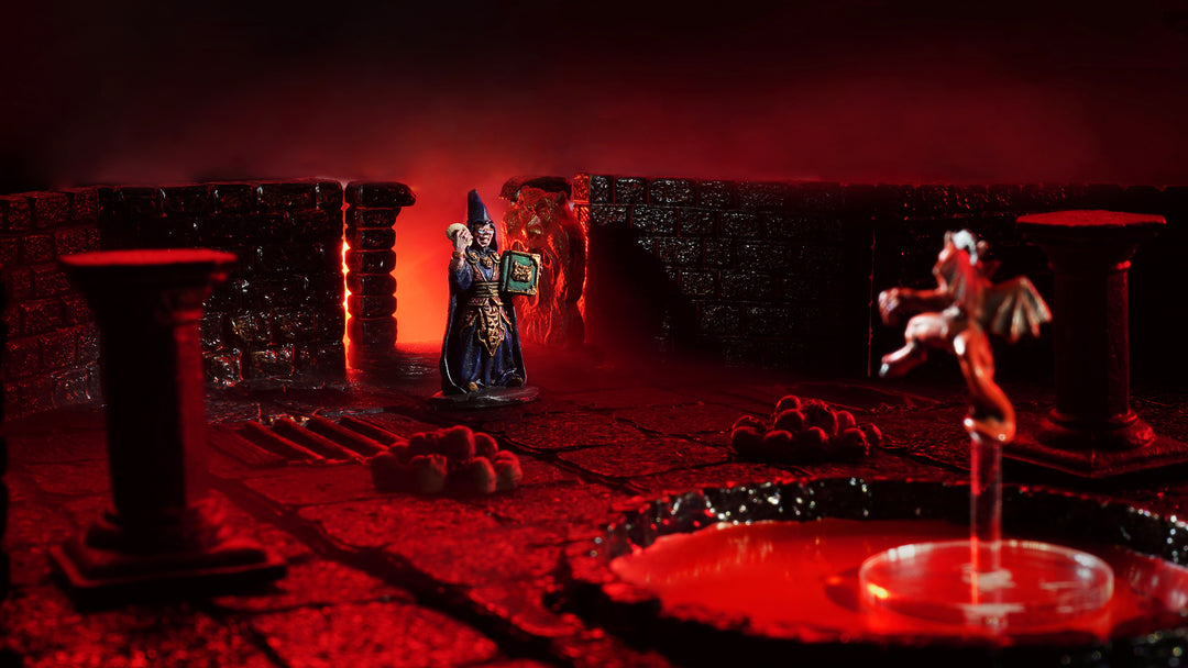 A red-lit dungeon using resin dungeon tiles from our original kickstarter. A wizard miniature, Zaltar, stands at the center, ready to take on a devil floating above a pool of blood.