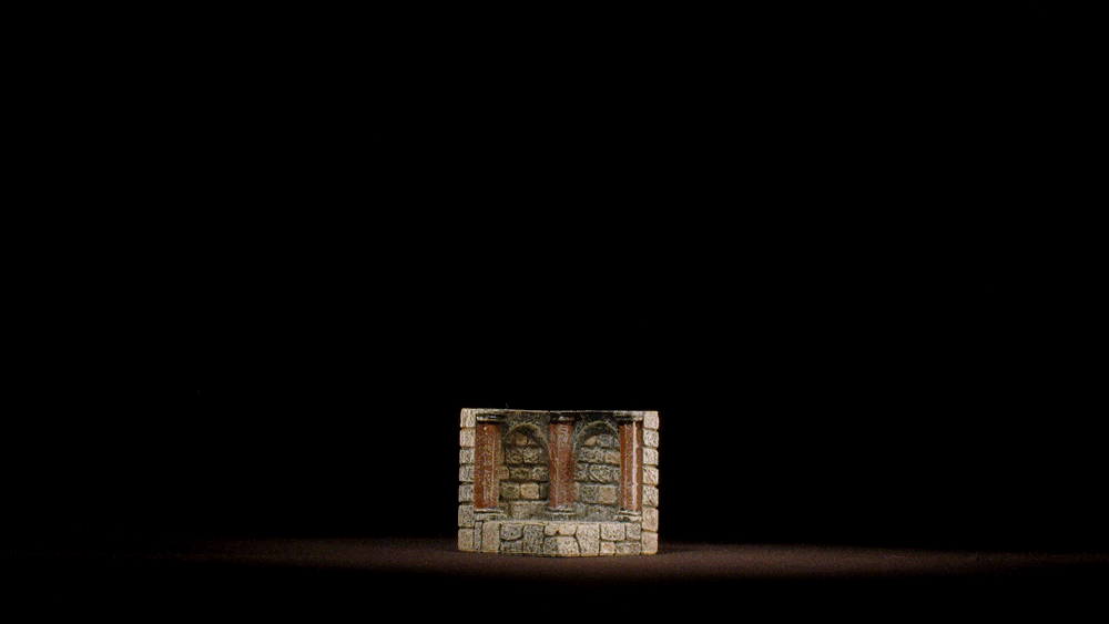 a hammer strikes a dungeon corner wall, demonstrating its durability