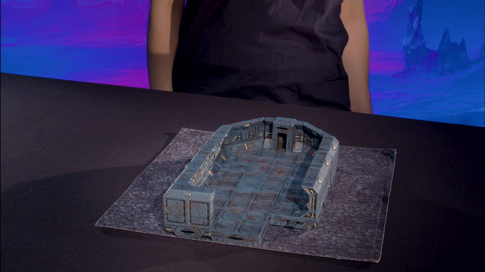 gif demonstrating the anchor magnets on the floors and walls of Starforged pieces adhering to the sheet metal interiors of our terrain trays. 